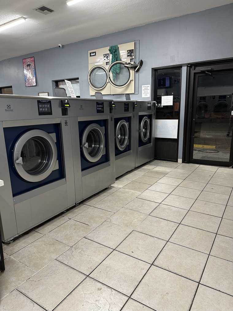 Blue front-load washing machines at Coastal Clean Laundromat